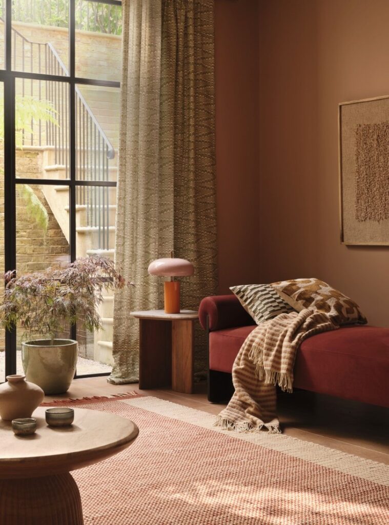 aubergine velvet daybed with green pattern curtain fabric plaster walls set design Rebecca de Boehmler